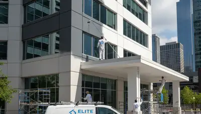 Professional commercial painters working on an office exterior in Plymouth, MA