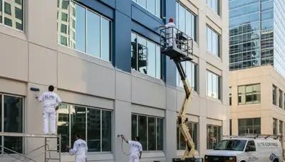Professional commercial painters refinishing office building exterior in Plymouth, MA