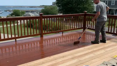 Professional deck staining in Plymouth MA enhancing wood color and protecting against coastal weather
