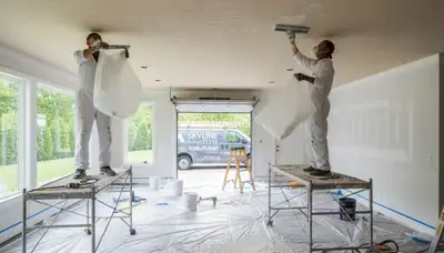 Professional popcorn ceiling removal in Plymouth MA home with smooth modern painted finish